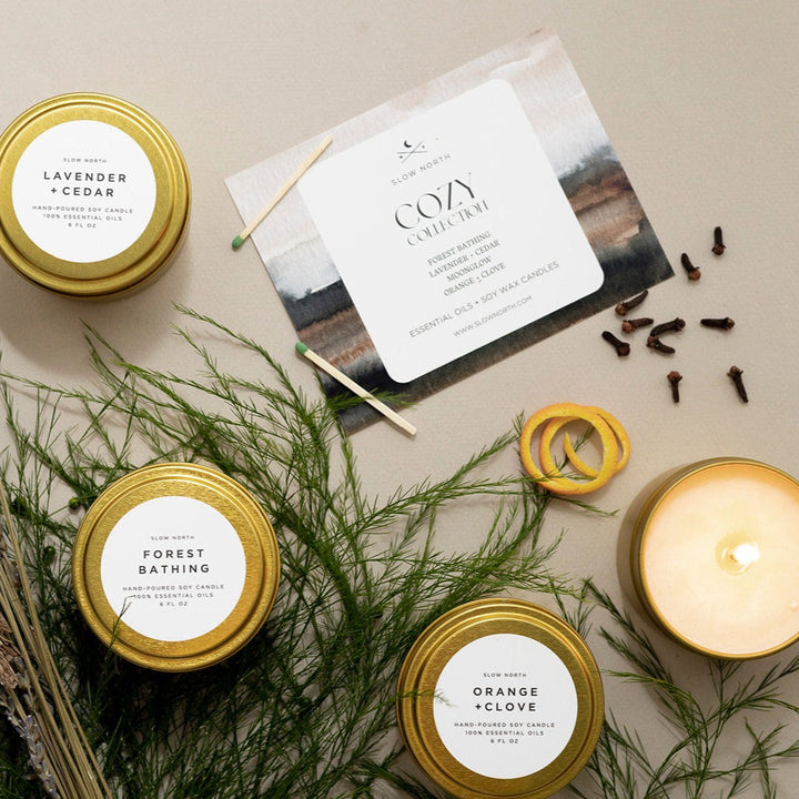 Cozy Collection four-pack of essential oil travel tin candles in a gift box.