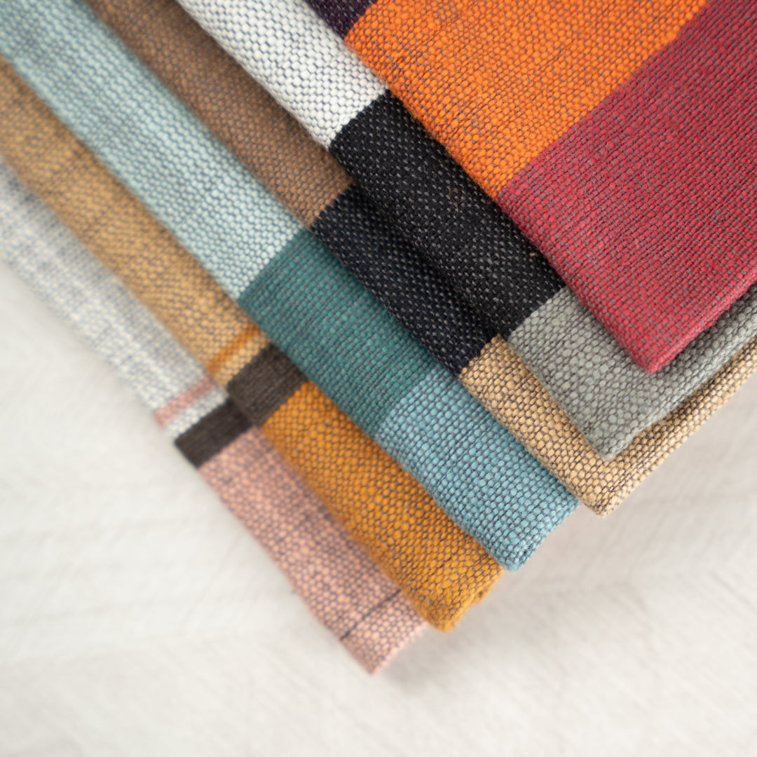 Close-up of the corners of stacked color block napkins