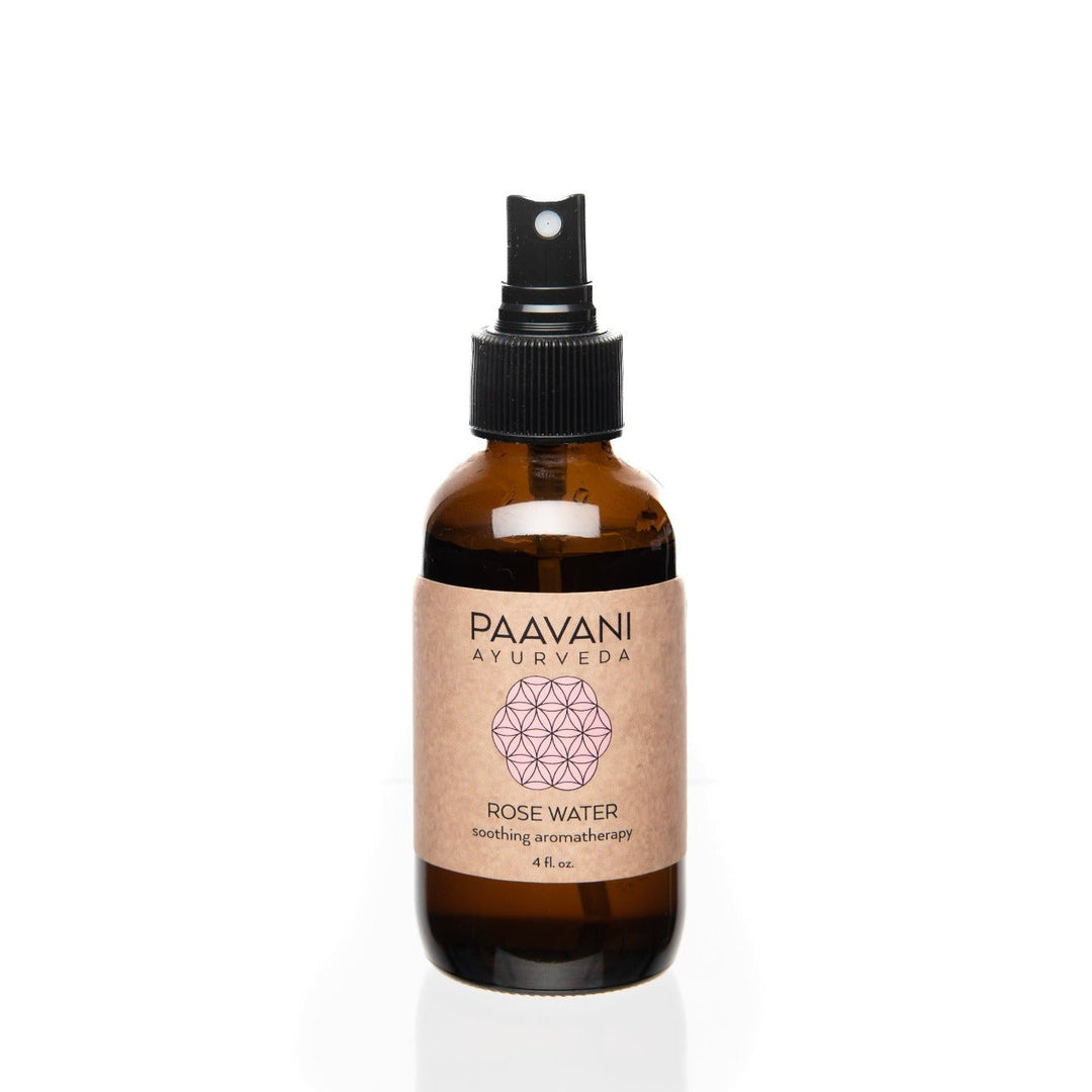 Organic Bulgarian rose water aromatherapy mist with a clear spray bottle and rose petals.
