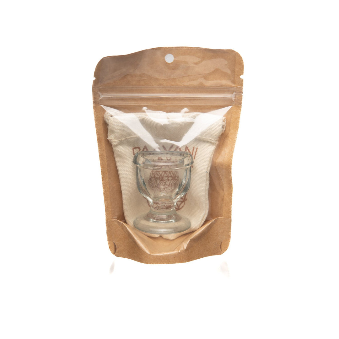 Glass eye wash cup with a rounded rim.