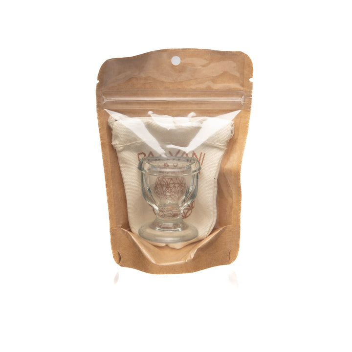 Glass eye wash cup with a rounded rim.