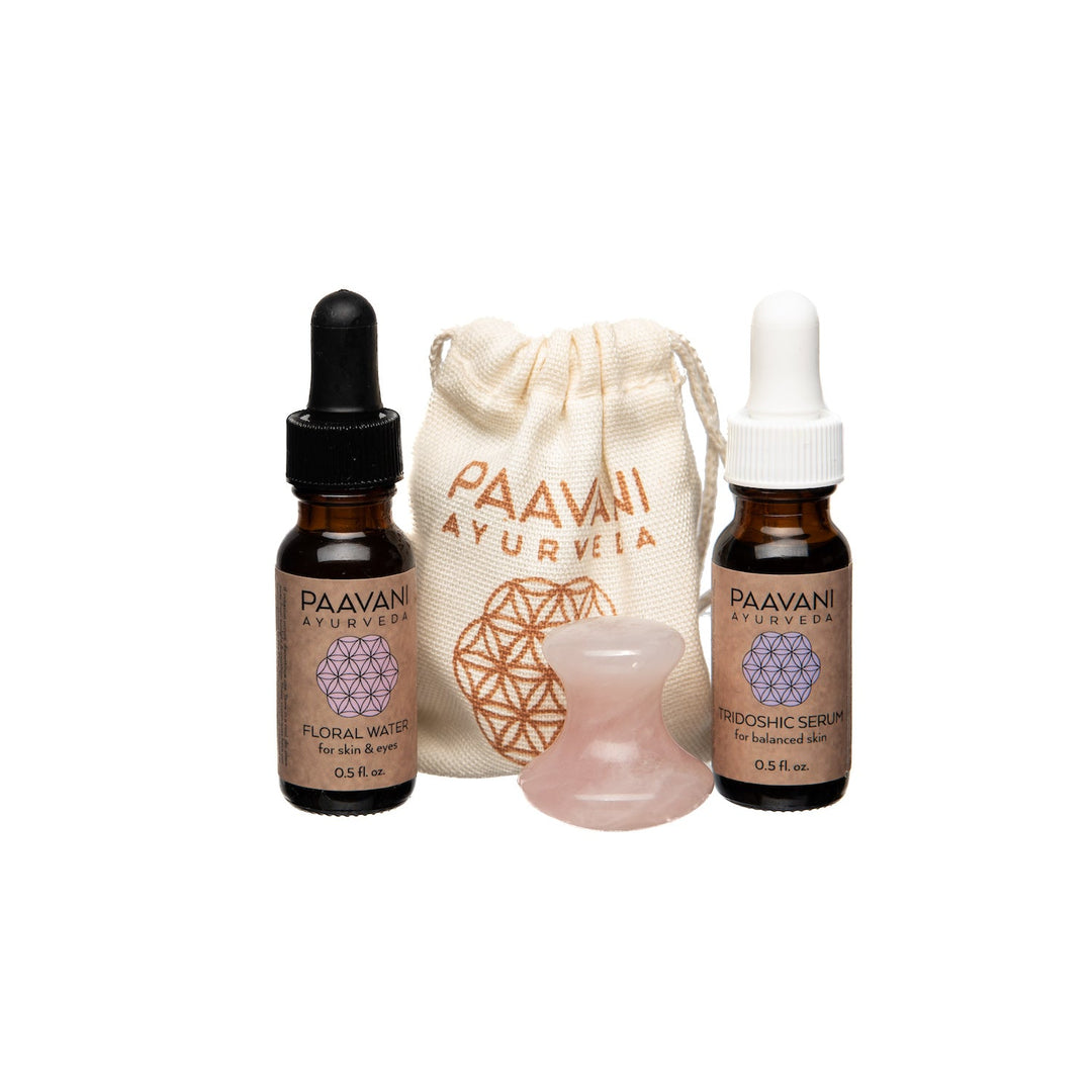Rose quartz facial tool, showing the smooth, polished stone and handle.