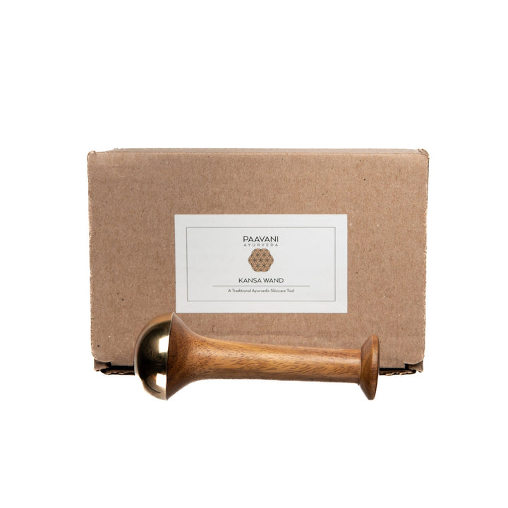 Kansa wand facial tool with a sheesham wood handle.