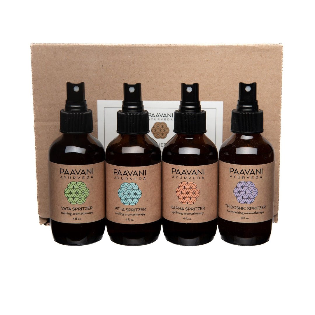 Aromatherapy ritual kit with Ayurvedic essential oil spritzers and accessories.