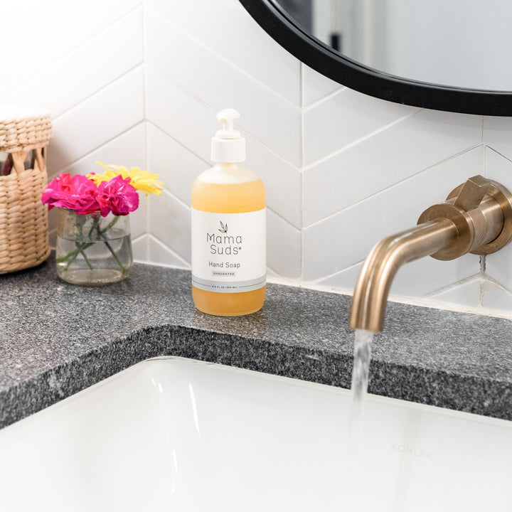 Olive oil and lemon hand soap bottle with label and natural ingredients.