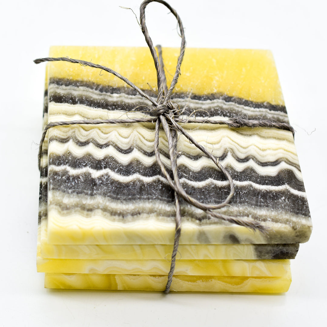 Set of onyx coasters with smooth polished edges and natural banding.