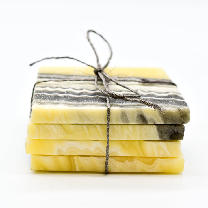 Four hand-carved onyx coasters for hot or cold drinks.
