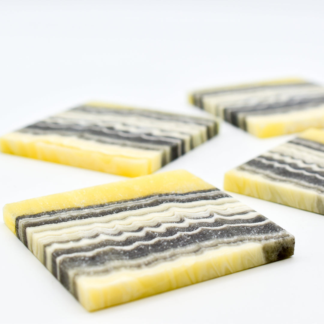 Onyx coaster set arranged on a wooden table.