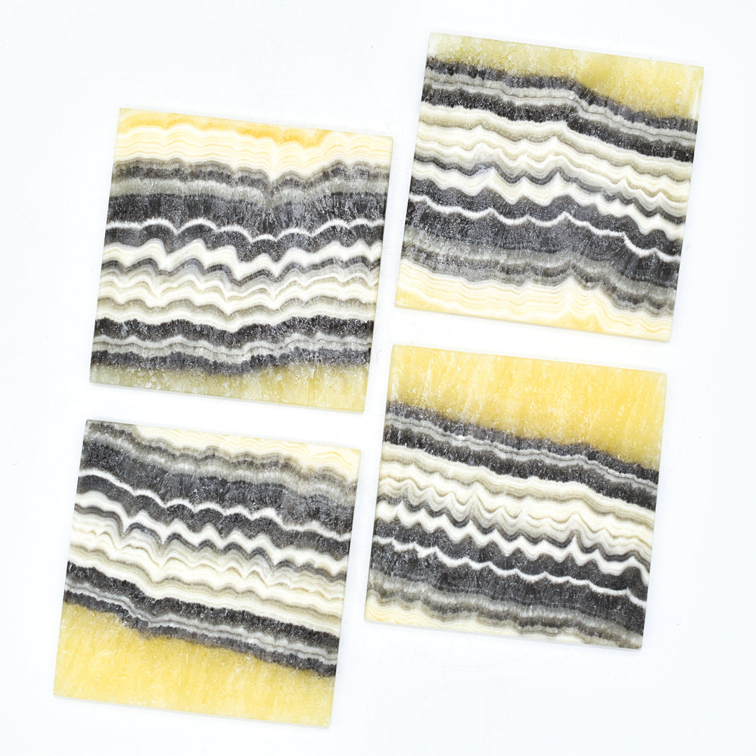 Onyx coasters with natural gold and dark veining, handmade in Mexico.