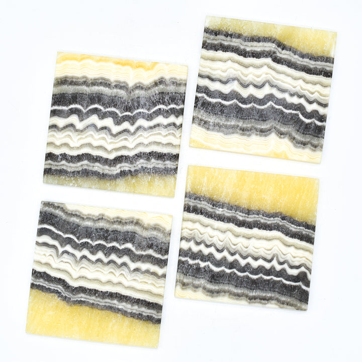Onyx coasters with natural gold and dark veining, handmade in Mexico.
