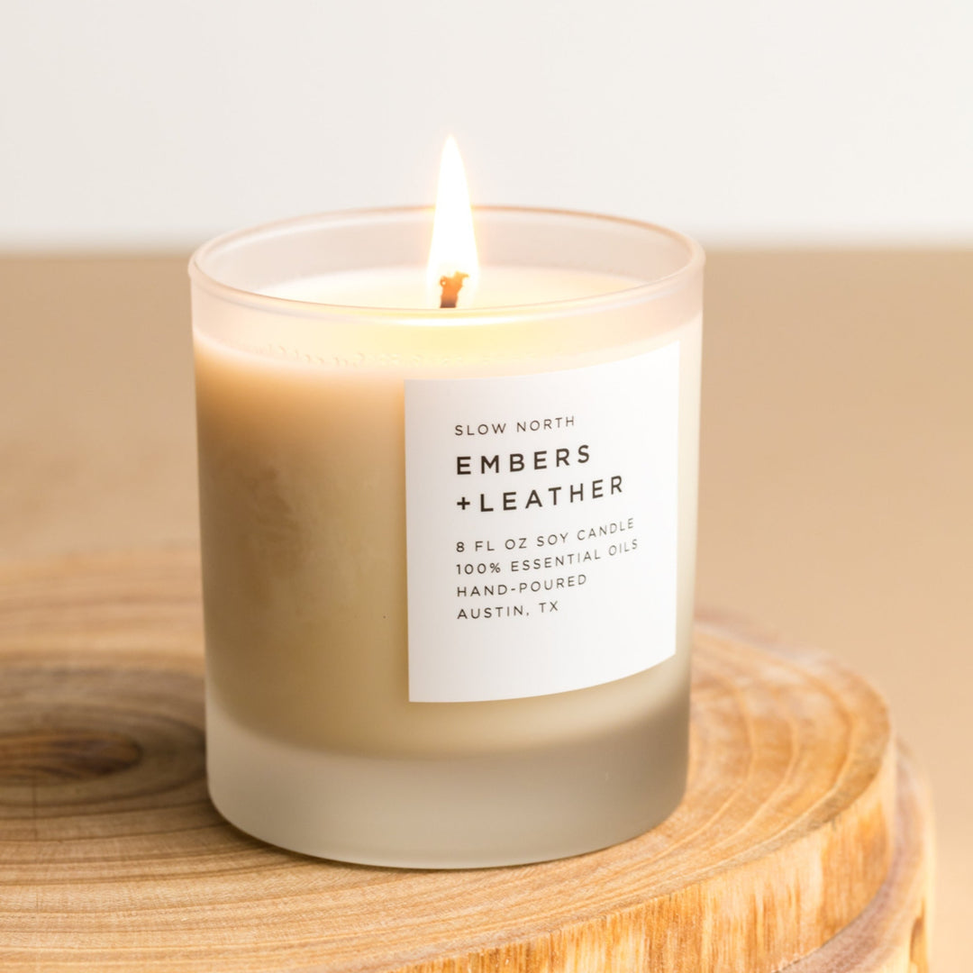 Embers &amp; Leather signature candle with warm rustic design and natural wax finish.