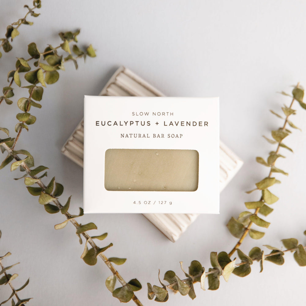 Rustic handcrafted bar soap styled with sprigs of fresh eucalyptus and lavender.