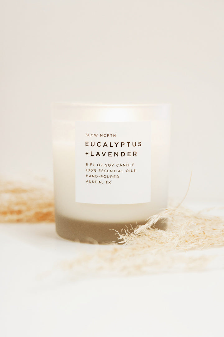 8 oz eucalyptus and lavender candle in a glass jar with a lit wick.