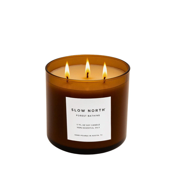 Forest Bathing three-wick candle with essential oils and forest-inspired design.