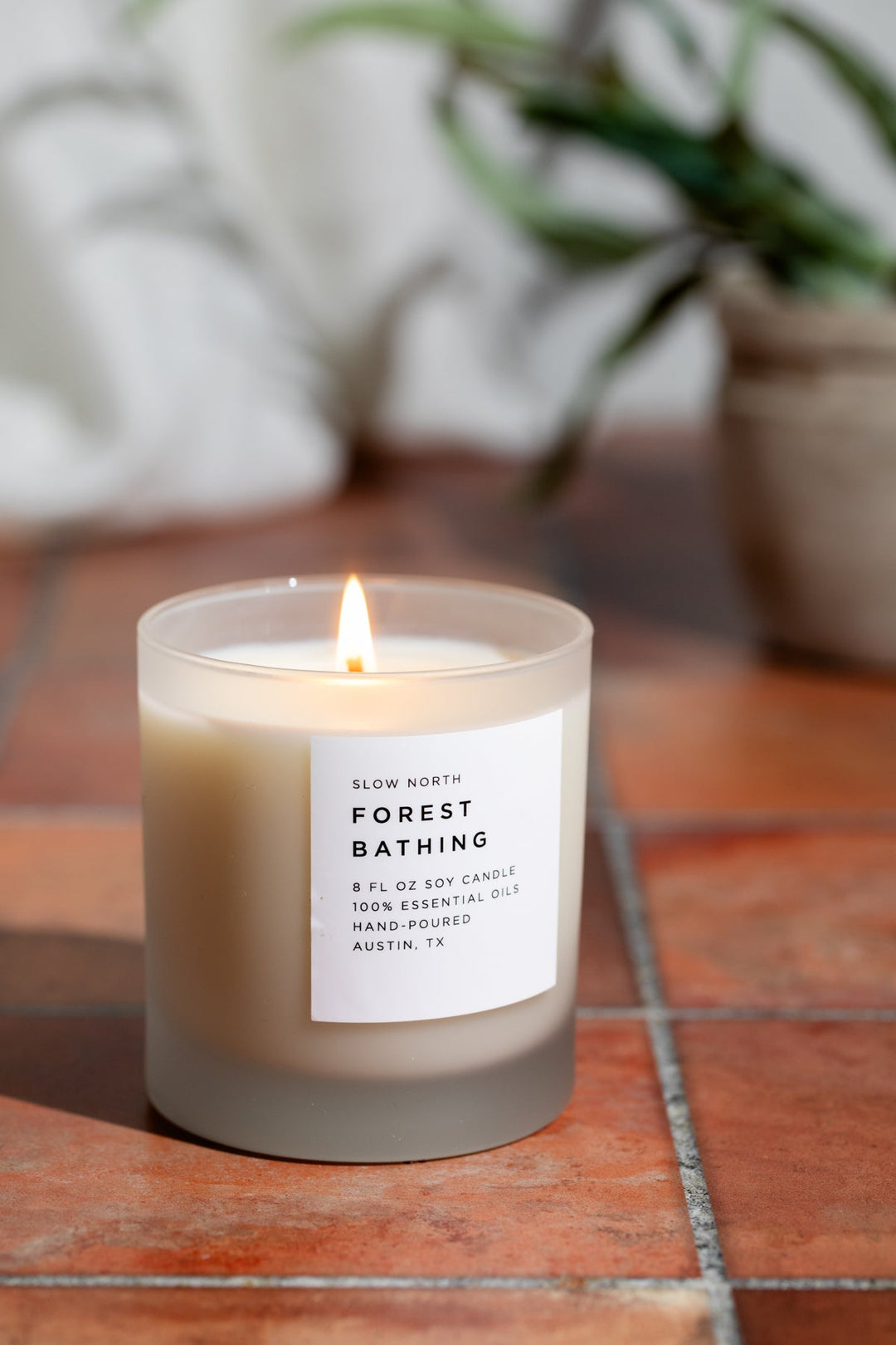 Forest Bathing candle with forest-themed label and wooden wick.