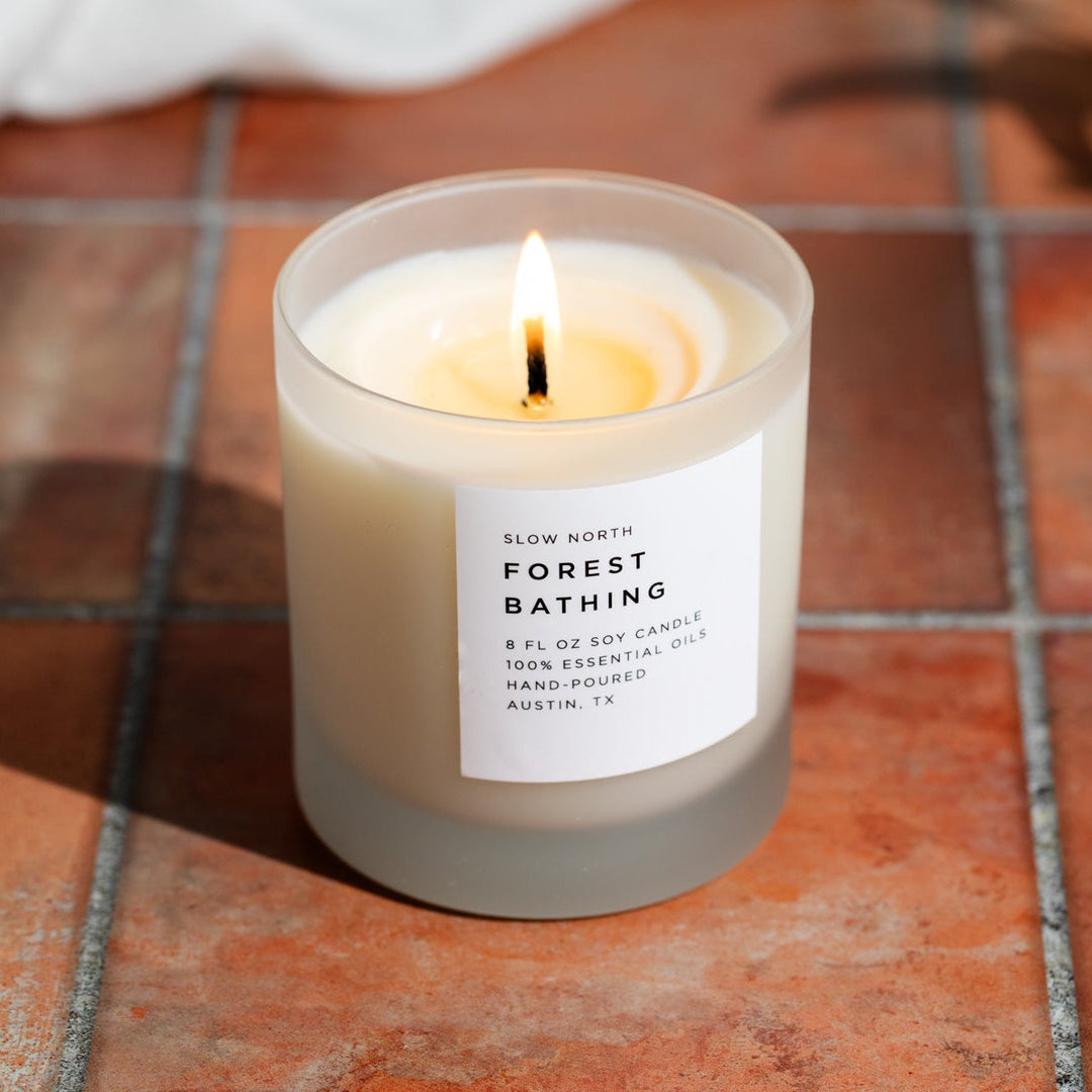 Forest Bathing candle styled in a natural woodland setting.