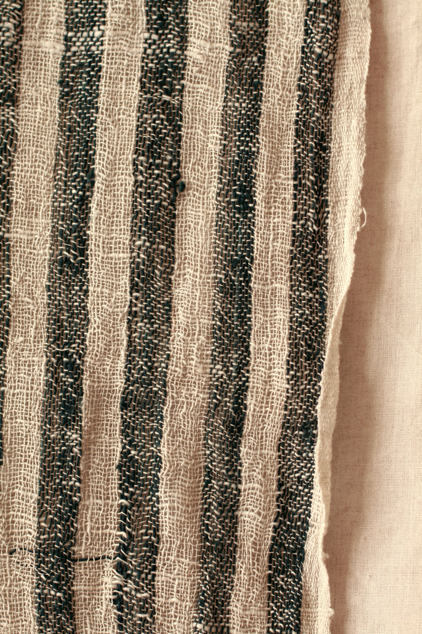 Black hand-loomed cotton scarf featuring intricate weaving and lightweight, soft fabric for stylish wear.
