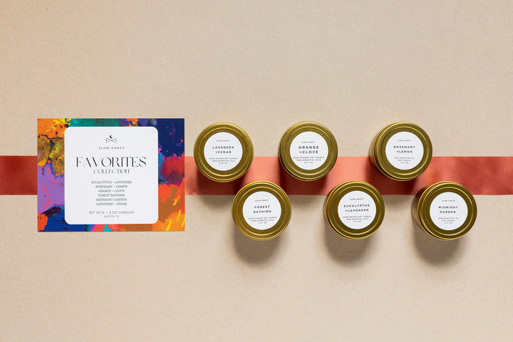 Six mini tin candles from the Favorites Collection with colorful packaging.