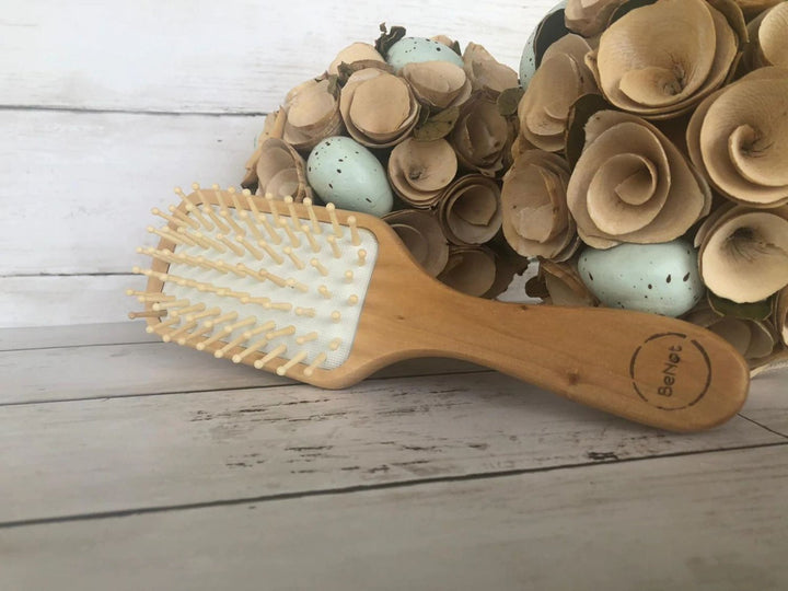 Bamboo detangling hair brush with a natural wood finish and flexible bristles for gentle hair detangling.