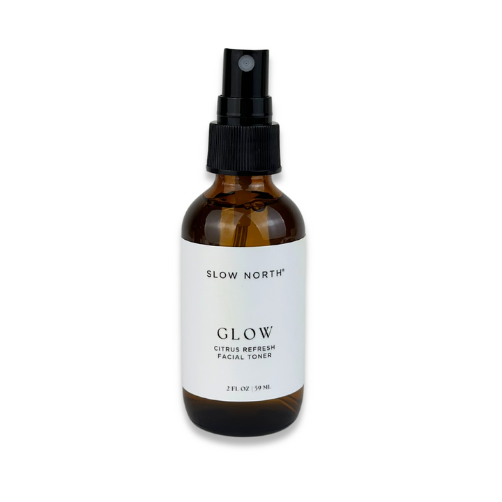 Glow Citrus Refresh facial toner in a clear bottle with bright citrus orange liquid.