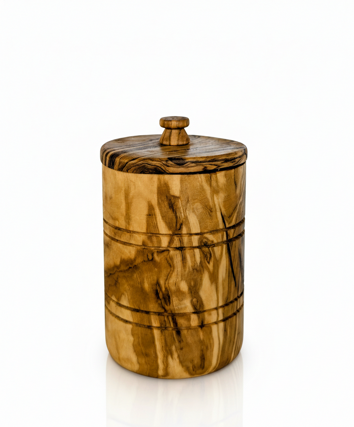Hand-carved olive wood spice jar with lid, showcasing natural wood grain and craftsmanship.