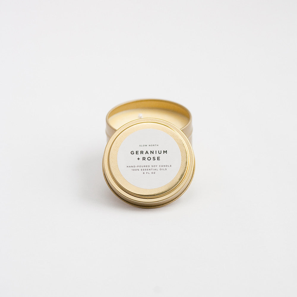 Geranium Rose travel tin candle with floral design and warm wax.