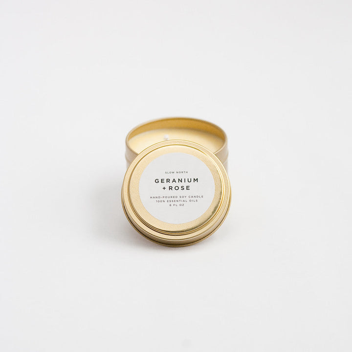 Geranium Rose travel tin candle with floral design and warm wax.
