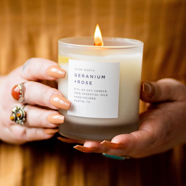 8 oz Geranium Rose signature candle with floral label design.