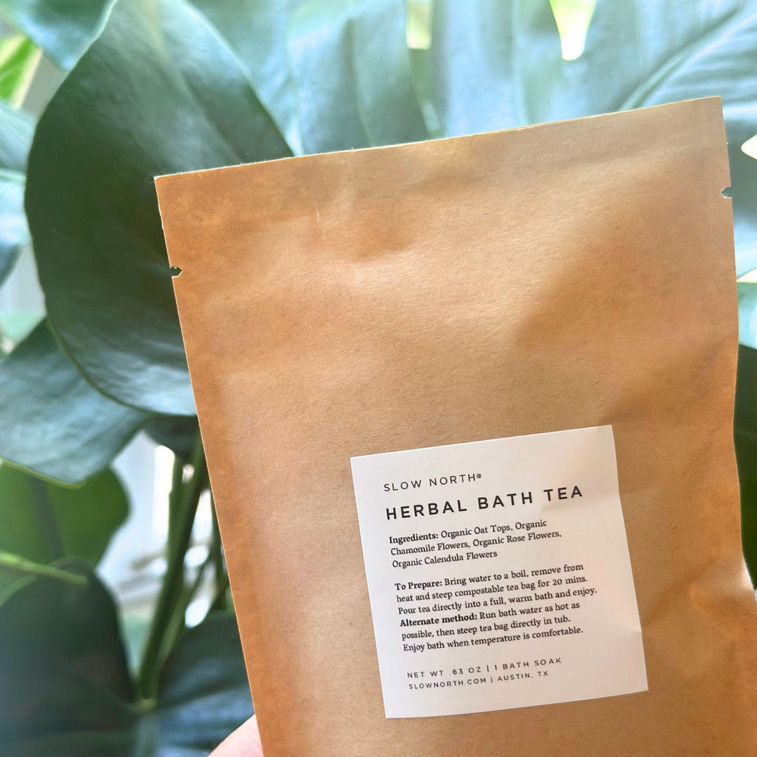 Single-soak bath tea with organic herbs in a clear glass jar.