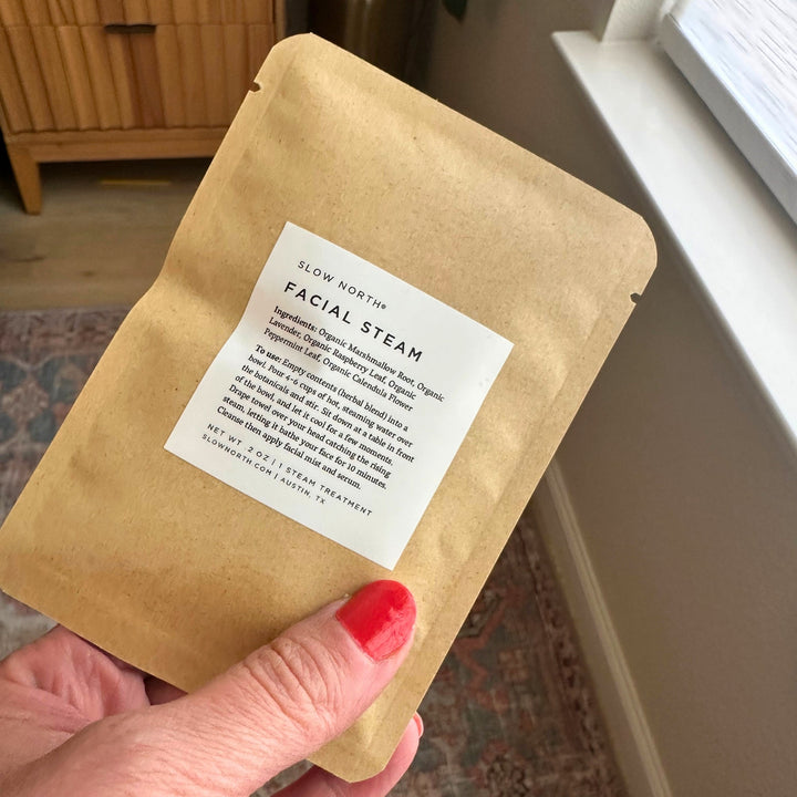 Herbal facial steam with five botanicals in a bowl with hot water.