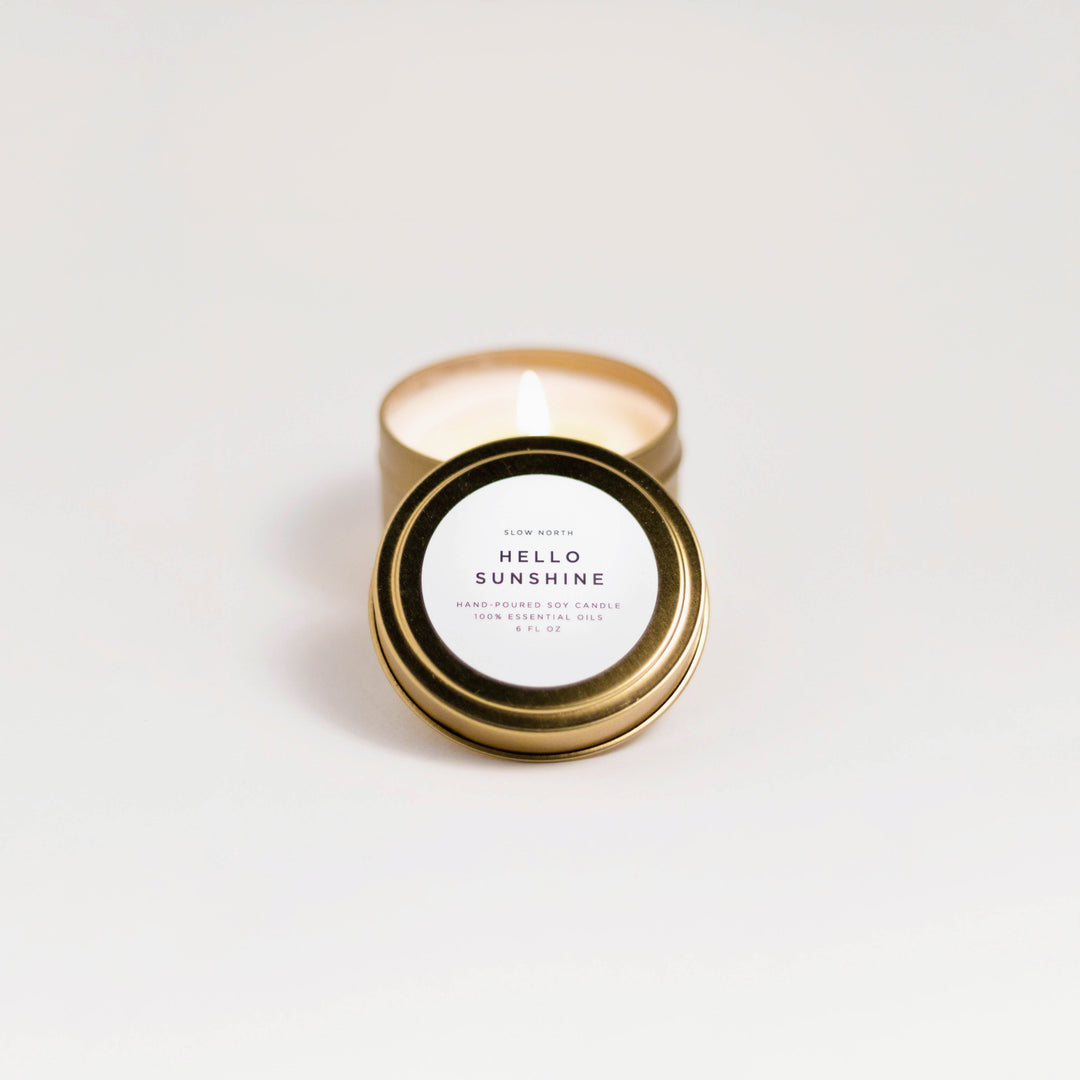 Hello Sunshine travel tin candle with citrus blend and sunny label design.