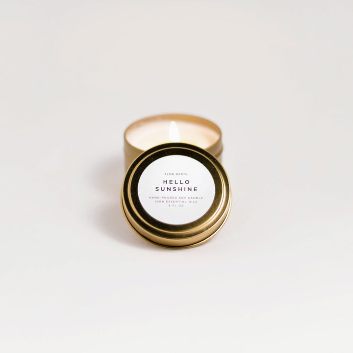 Hello Sunshine travel tin candle with citrus blend and sunny label design.