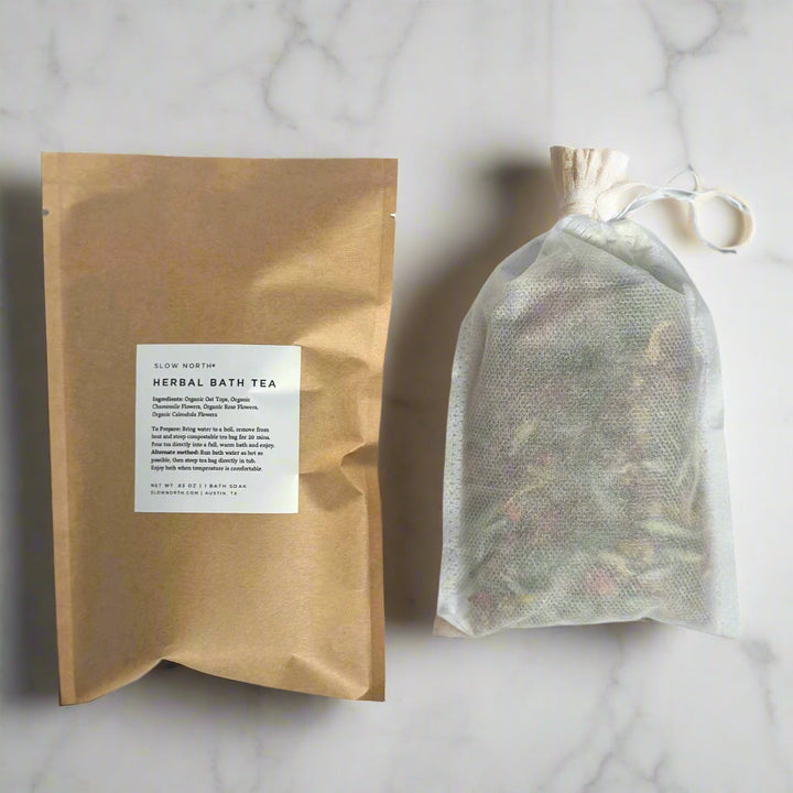Single-serve herbal bath tea in a compostable tea bag with dried herbs and flowers.