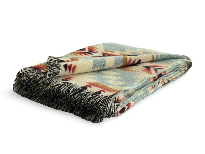 Vibrant Mint Andean throw folded, showing the tasseled fringe edge.