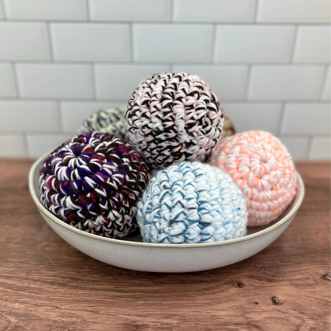 Handmade dryer ball made from upcycled yarn and fabric, for laundry use.