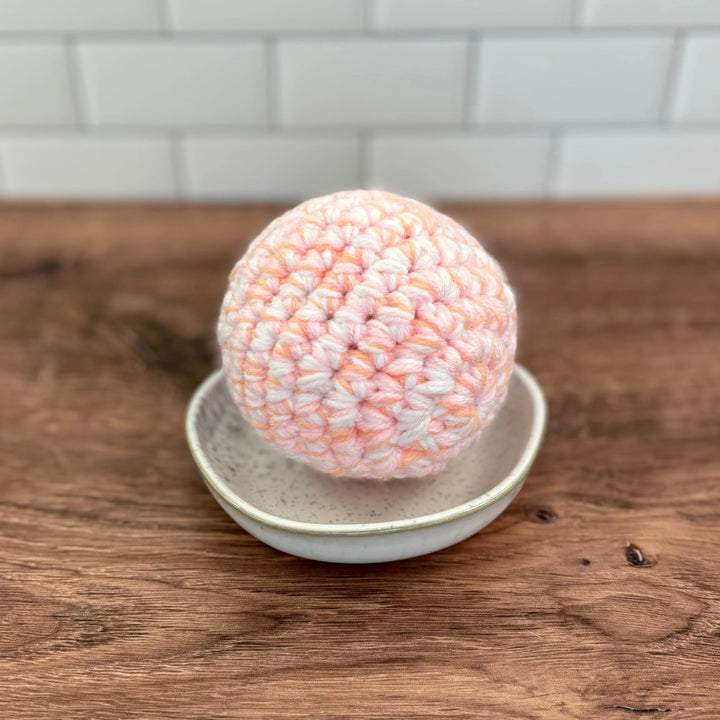 Handmade upcycled-textile dryer ball that softens clothes in the dryer.