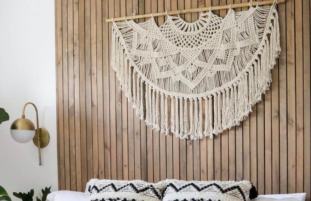 Natural white macrame wall hanging with an intricate woven, textured design.