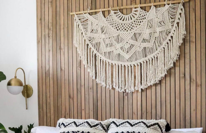 Natural white macrame wall hanging with an intricate woven, textured design.