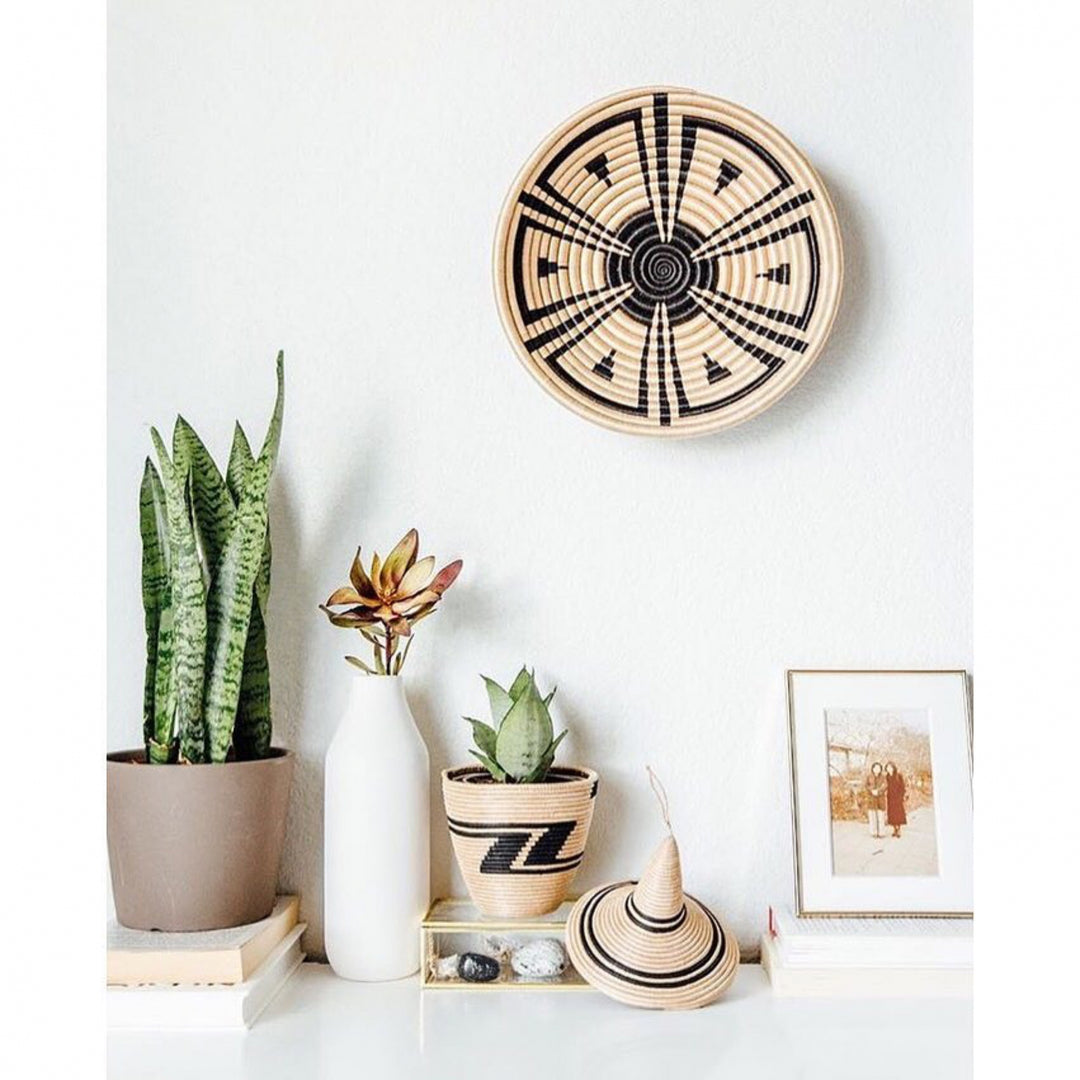 Akazi woven bowls with a radiating line-burst pattern in natural sisal.