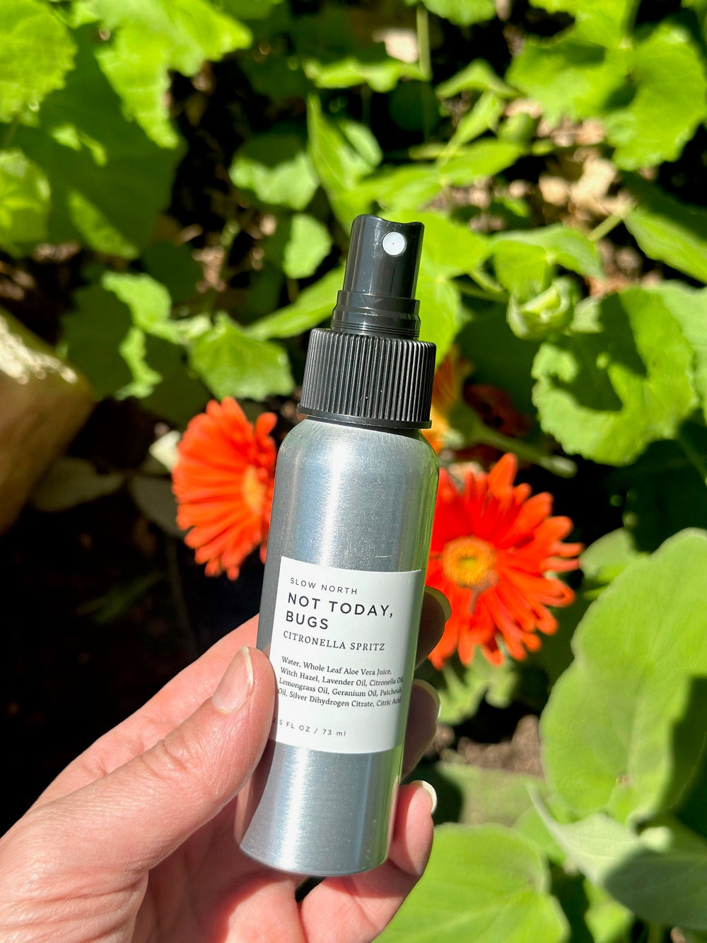 Travel-size natural bug spray with essential oils and labeled aluminum bottle.