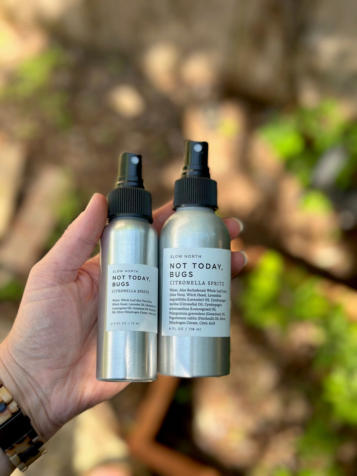 Travel-size bug spray with natural essential oil blend on a neutral background.