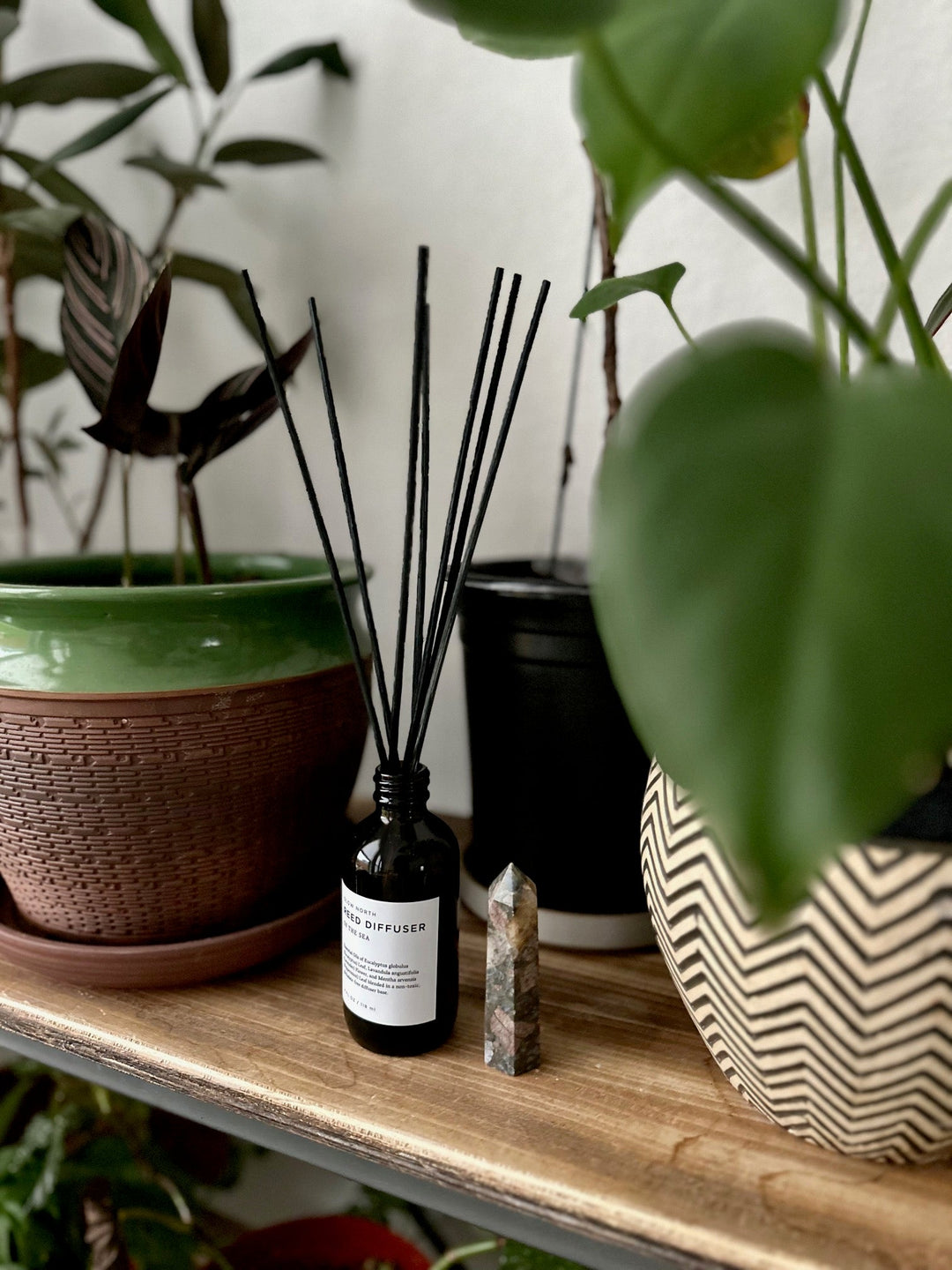 Reed diffuser with calming eucalyptus scent in elegant glass packaging.