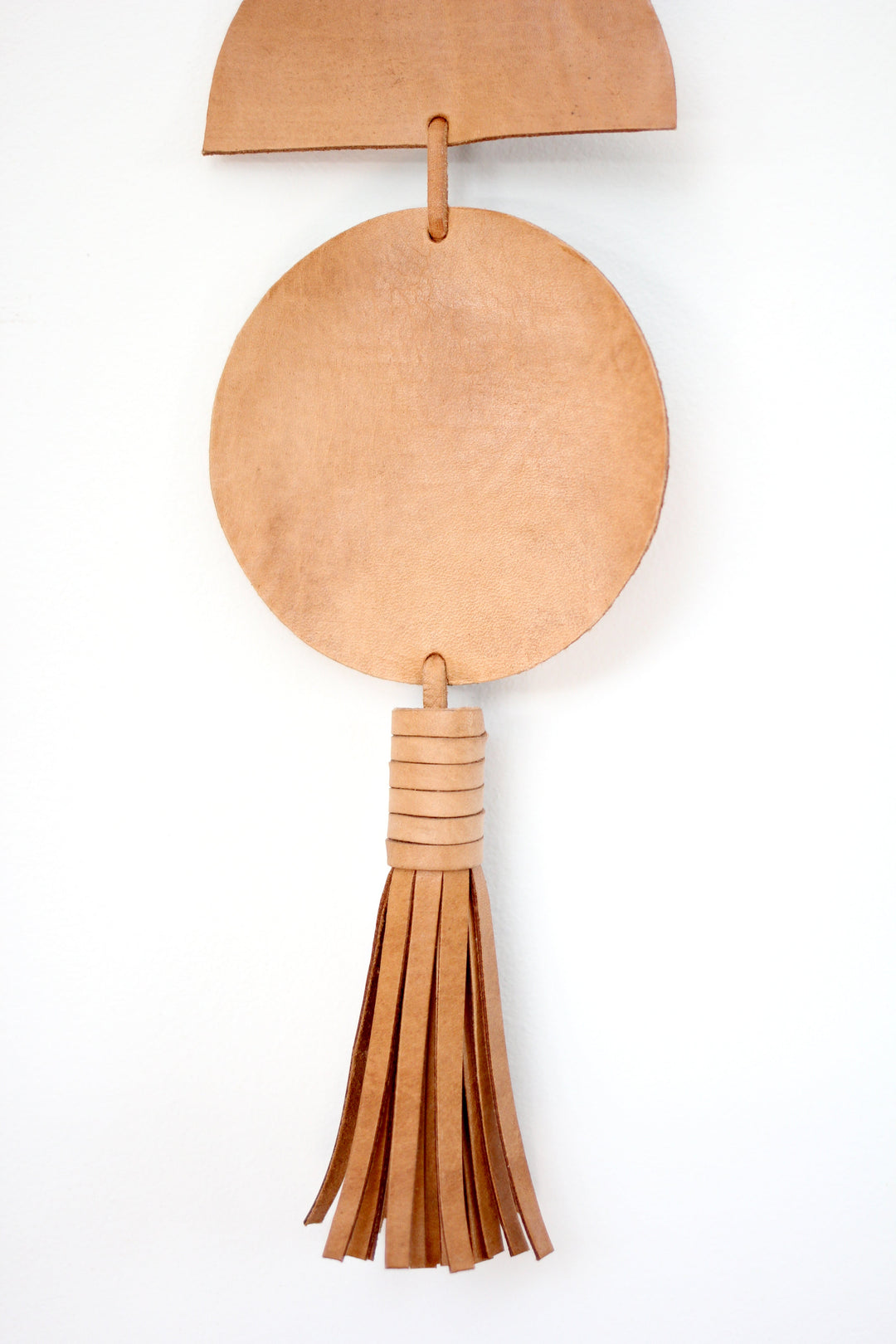 Large leather Luna moon-phase wall hanging with crescent and full moons.