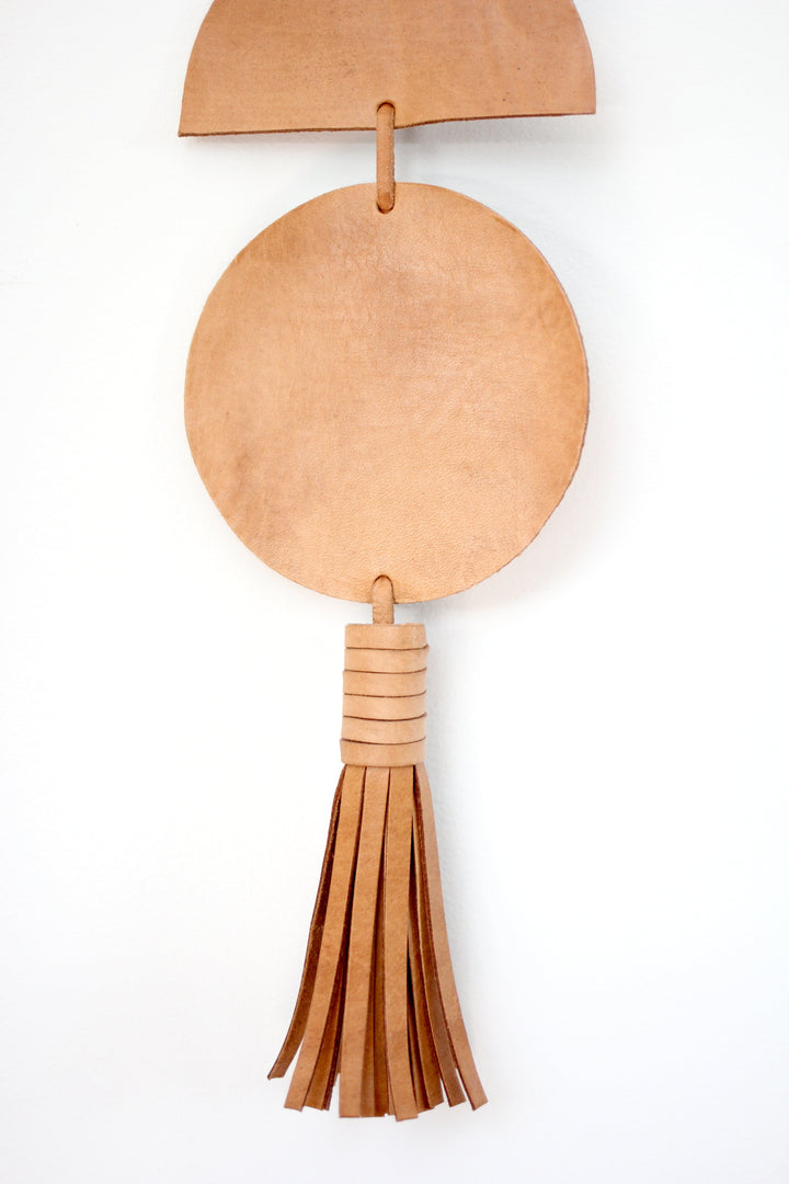 Large leather Luna moon-phase wall hanging with crescent and full moons.
