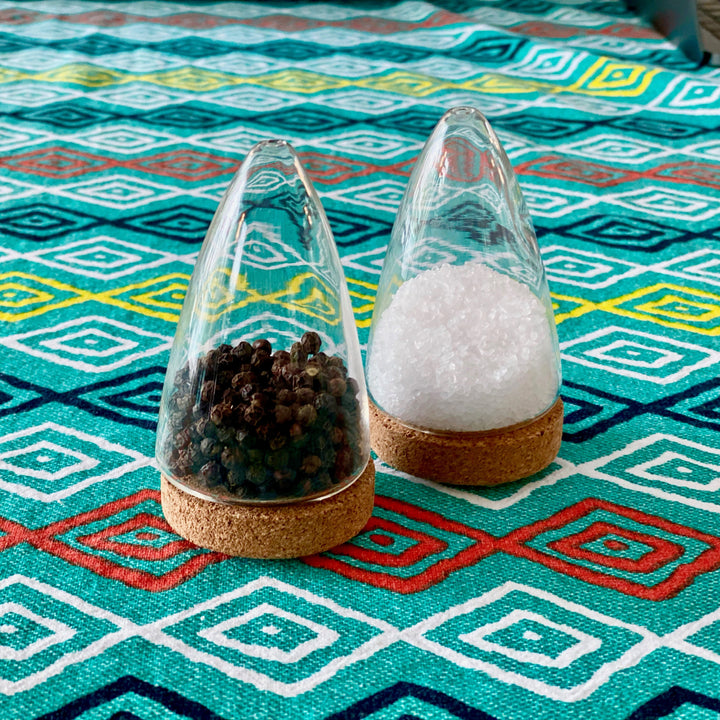Glass salt and pepper shakers with cork stoppers and clear glass bodies, set of two.