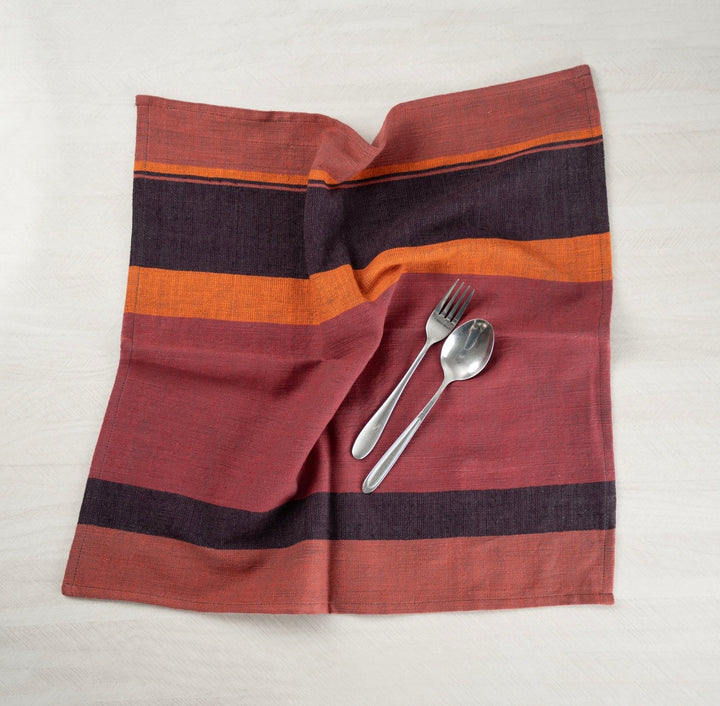 Color block napkin laid open with a spoon and fork