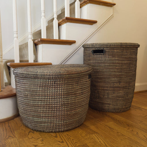 Black handwoven storage basket with flat lid and textured woven design.