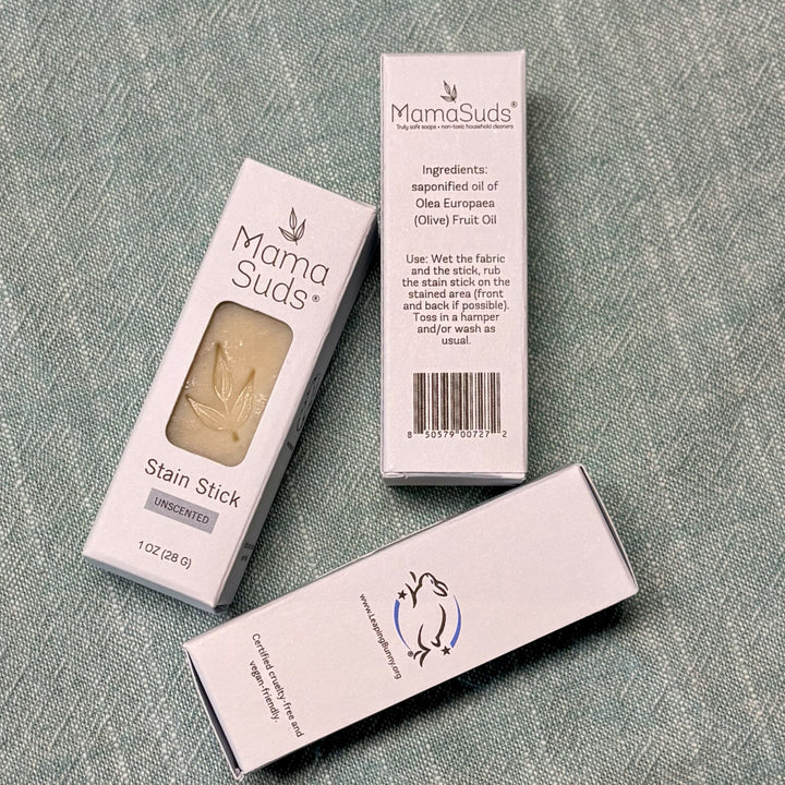 Olive-oil laundry stain stick being applied to fabric.
