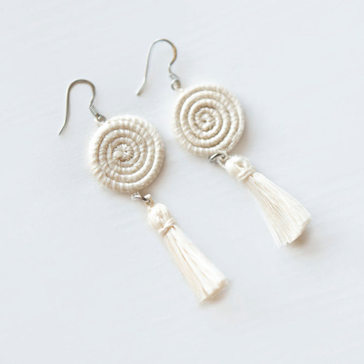 White handwoven sisal tassel earrings with a natural-fiber tassel design.