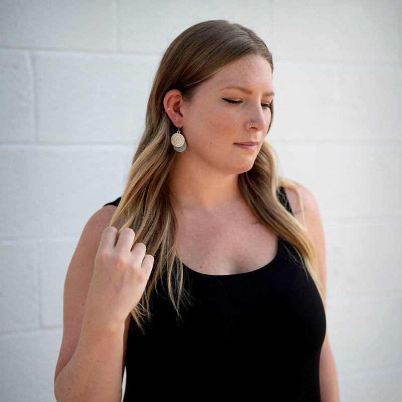 Ice blue woven disc earrings made from sisal fiber.